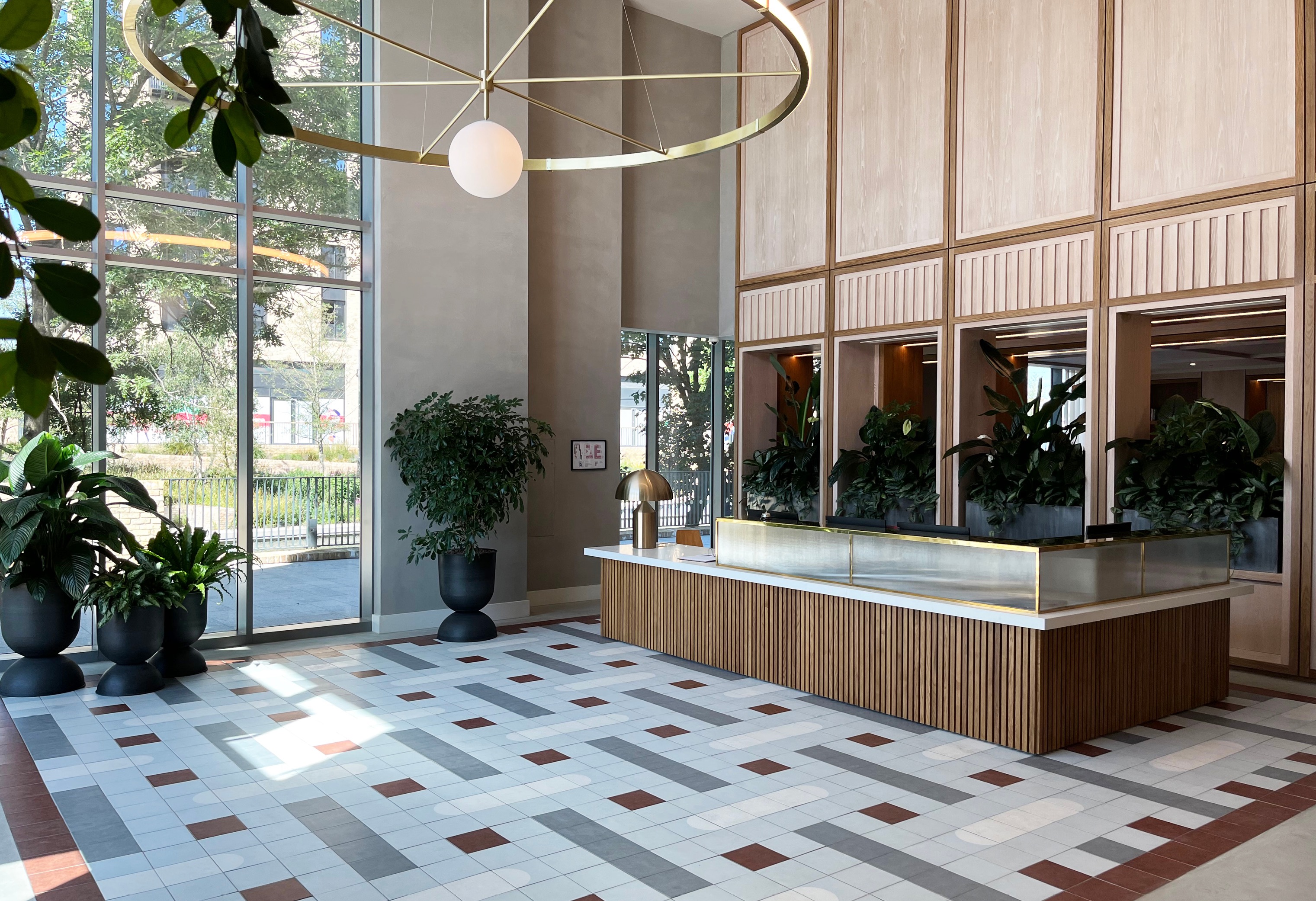 Modern lobby with sophisticated reception design and geometric flooring